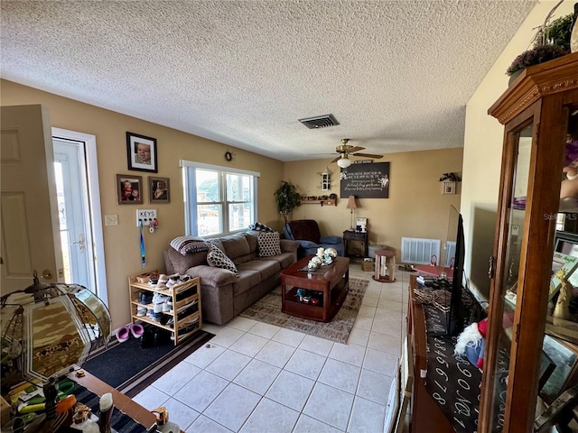 8053 Hixton Dr, Port Richey, FL 34668 - living room with light tile patterned floors, a ceiling fan, and a textured ceiling