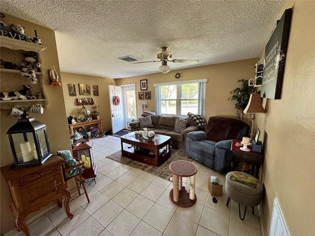 8053 Hixton Dr, Port Richey, FL 34668 - living area featuring light tile patterned floors, a ceiling fan, and a textured ceiling