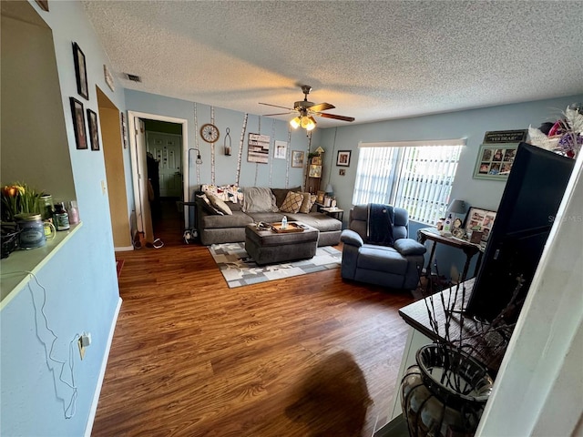 8053 Hixton Dr, Port Richey, FL 34668 - living area featuring wood finished floors, a ceiling fan, and a textured ceiling