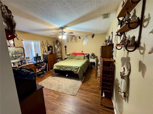 8053 Hixton Dr, Port Richey, FL 34668 - bedroom with wood finished floors, a ceiling fan, and a textured ceiling