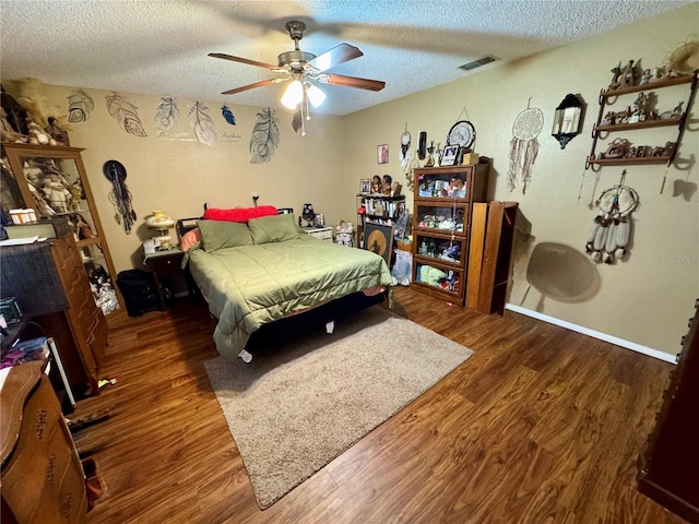 8053 Hixton Dr, Port Richey, FL 34668 - bedroom with a textured ceiling, wood finished floors, baseboards, and a ceiling fan