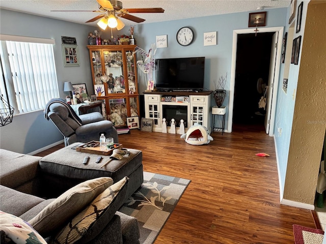 8053 Hixton Dr, Port Richey, FL 34668 - living room featuring a ceiling fan, wood finished floors, a textured ceiling, and baseboards