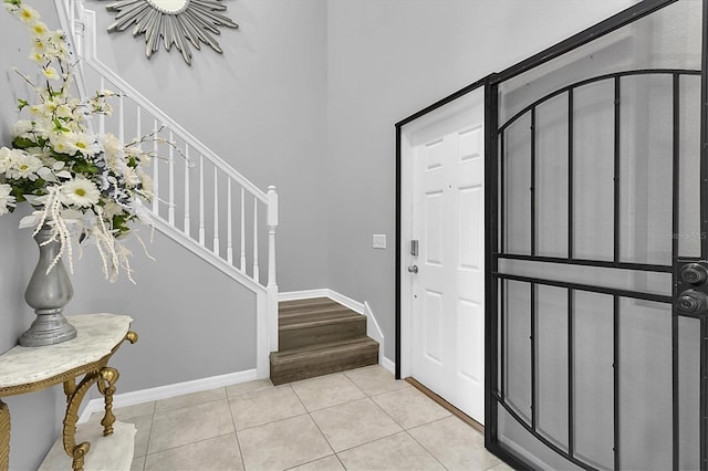 11895 Crestridge Loop, New Port Richey, FL 34655 - entryway with baseboards, stairs, and light tile patterned floors