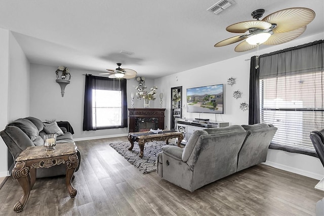 11895 Crestridge Loop, New Port Richey, FL 34655 - living room featuring baseboards, visible vents, wood finished floors, and a ceiling fan