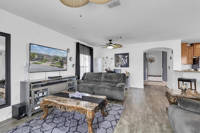 11895 Crestridge Loop, New Port Richey, FL 34655 - living room with a ceiling fan, arched walkways, wood finished floors, and visible vents
