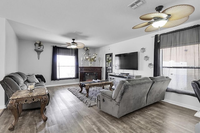 11895 Crestridge Loop, New Port Richey, FL 34655 - living room with baseboards, visible vents, wood finished floors, and a ceiling fan
