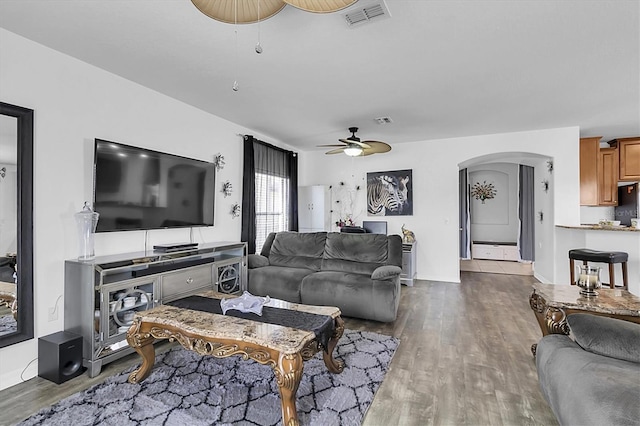 11895 Crestridge Loop, New Port Richey, FL 34655 - living area featuring wood finished floors, visible vents, arched walkways, and ceiling fan
