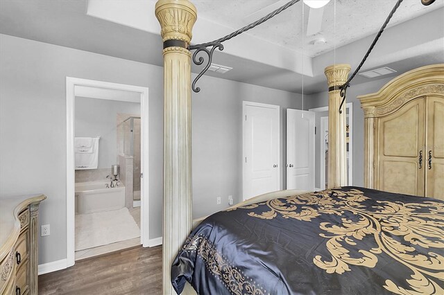 11895 Crestridge Loop, New Port Richey, FL 34655 - bedroom featuring dark wood finished floors, baseboards, visible vents, and connected bathroom