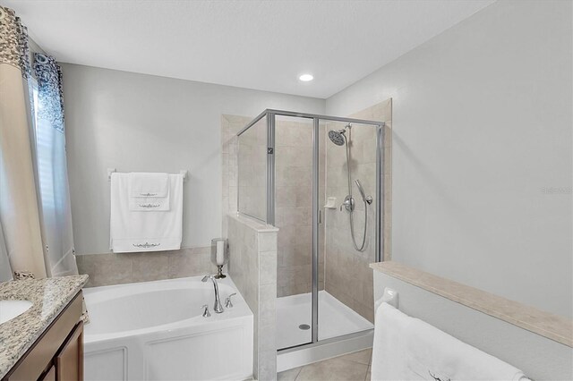 11895 Crestridge Loop, New Port Richey, FL 34655 - bathroom featuring tile patterned flooring, vanity, a garden tub, and a shower stall