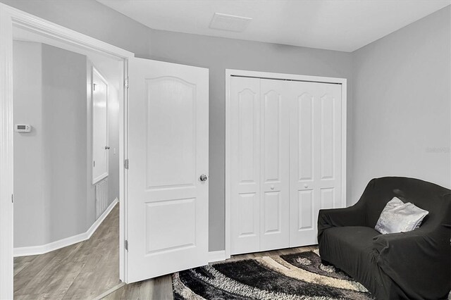 11895 Crestridge Loop, New Port Richey, FL 34655 - sitting room featuring baseboards, visible vents, and wood finished floors