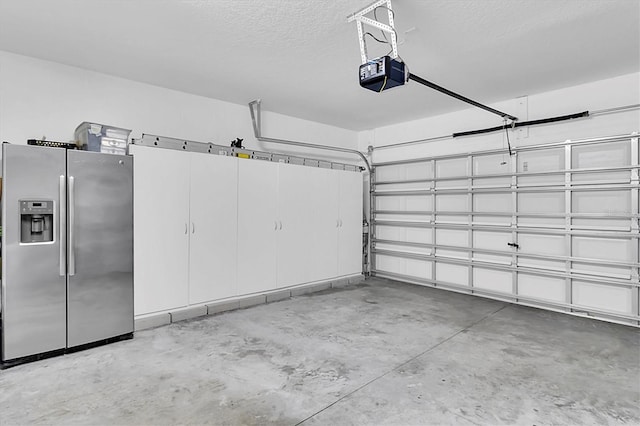 11895 Crestridge Loop, New Port Richey, FL 34655 - garage with stainless steel fridge with ice dispenser and a garage door opener