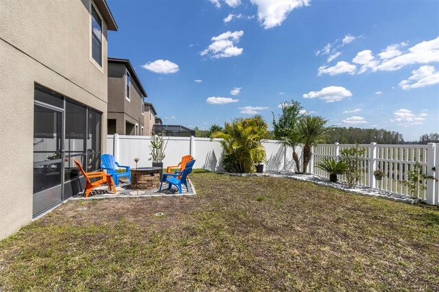 11895 Crestridge Loop, New Port Richey, FL 34655 - view of yard featuring a fenced backyard and a fire pit