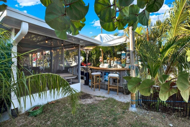 exterior space featuring outdoor dry bar and a patio