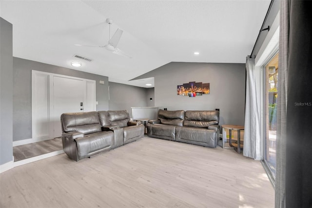 8626 White Springs Dr, New Port Richey, FL 34655 - living area with ceiling fan, visible vents, vaulted ceiling, and light wood finished floors