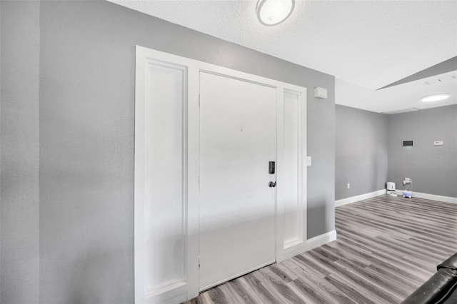 8626 White Springs Dr, New Port Richey, FL 34655 - washroom featuring baseboards, wood finished floors, and a textured ceiling