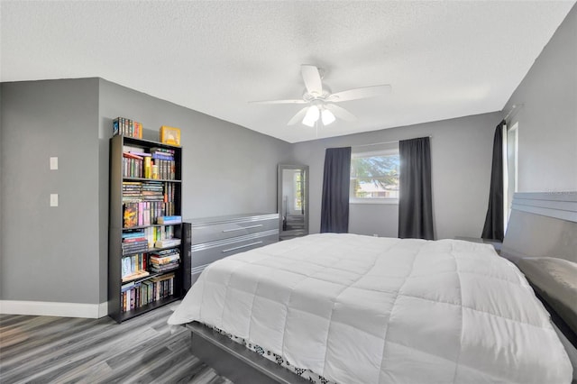 8626 White Springs Dr, New Port Richey, FL 34655 - bedroom with baseboards, wood finished floors, ceiling fan, and a textured ceiling