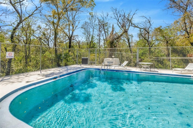 8626 White Springs Dr, New Port Richey, FL 34655 - community pool featuring a patio area and fence