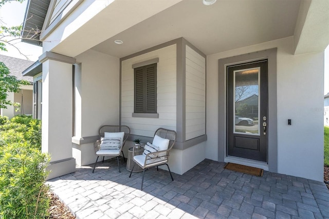doorway to property with a patio area and stucco siding