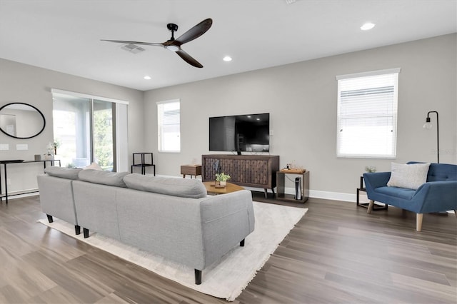 living room featuring recessed lighting, wood finished floors, visible vents, a ceiling fan, and baseboards