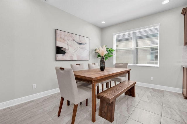 dining space featuring recessed lighting and baseboards