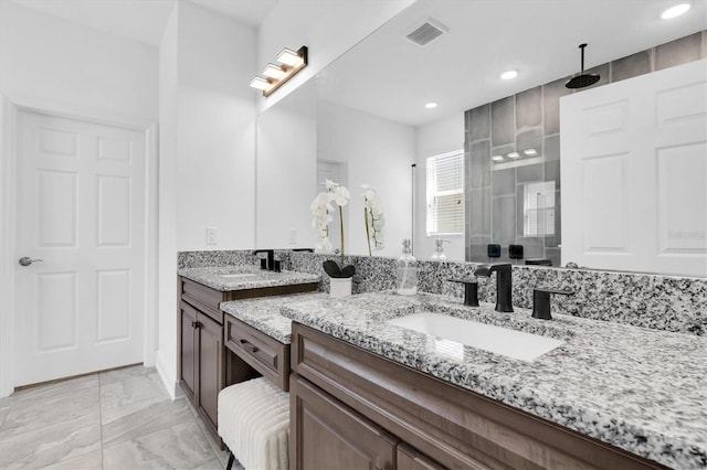 full bathroom featuring recessed lighting, marble finish floor, visible vents, vanity, and tiled shower