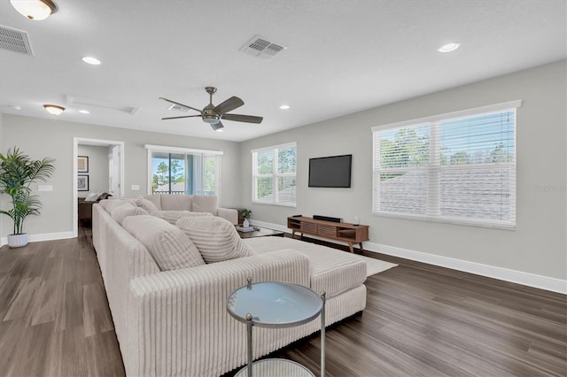 living area with baseboards, wood finished floors, visible vents, and recessed lighting