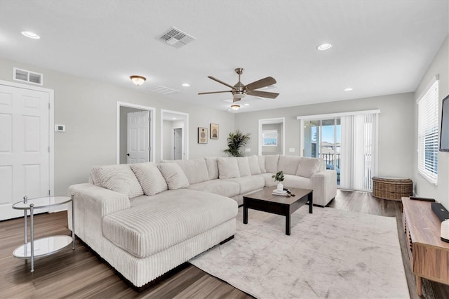 living area featuring wood finished floors, visible vents, recessed lighting, and a ceiling fan
