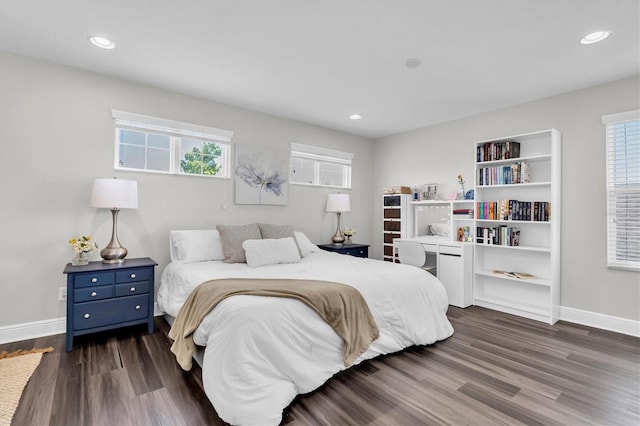 bedroom featuring dark wood finished floors, baseboards, and multiple windows