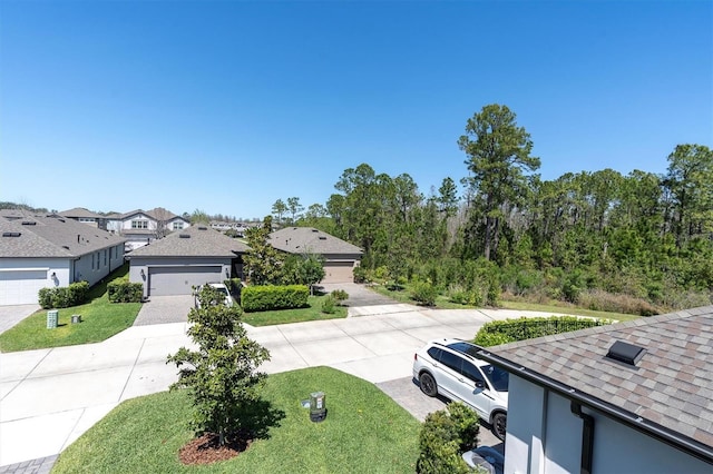 exterior space with driveway and a residential view