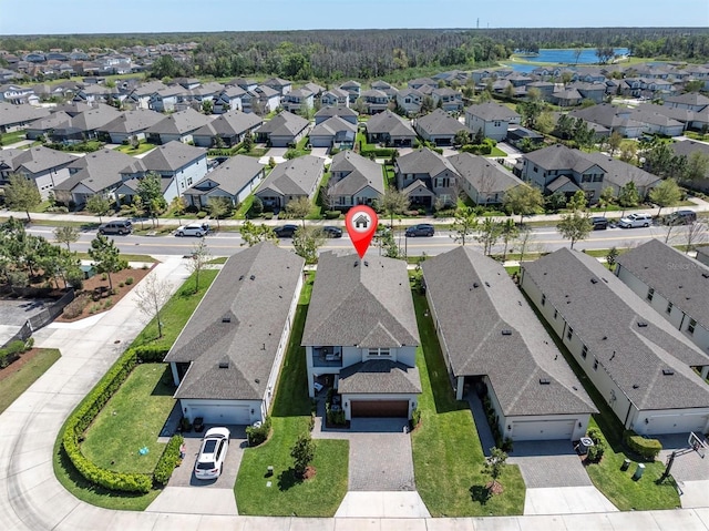 bird's eye view with a residential view and a water view