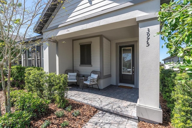 doorway to property with stucco siding