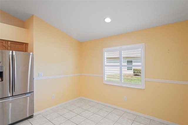 303 Rochester St, Spring Hill, FL 34609 - kitchen featuring light tile patterned floors, baseboards, recessed lighting, stainless steel fridge with ice dispenser, and brown cabinets