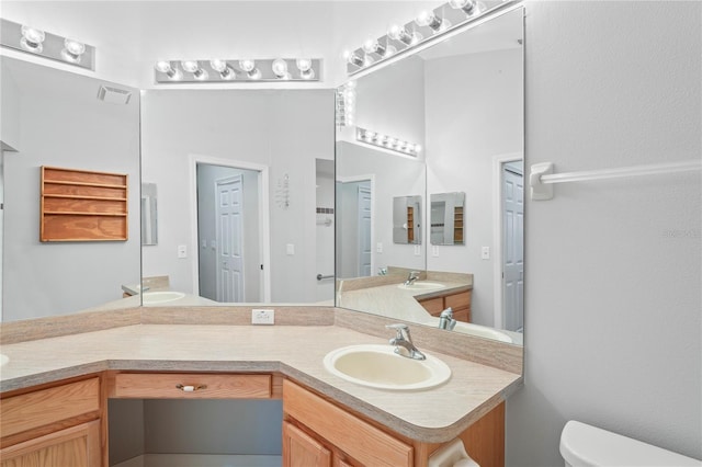 303 Rochester St, Spring Hill, FL 34609 - bathroom featuring vanity, toilet, and visible vents