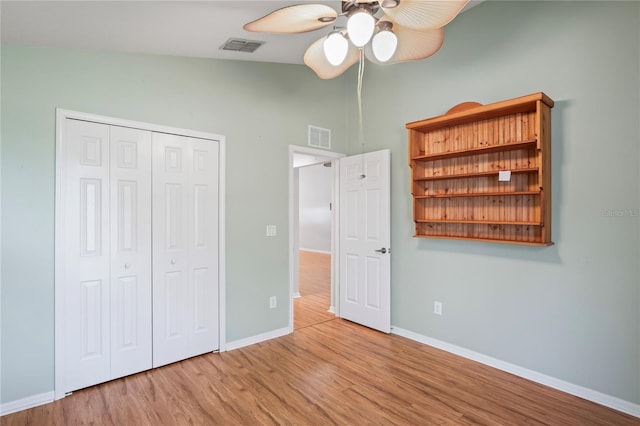 303 Rochester St, Spring Hill, FL 34609 - unfurnished bedroom featuring vaulted ceiling, baseboards, visible vents, and wood finished floors