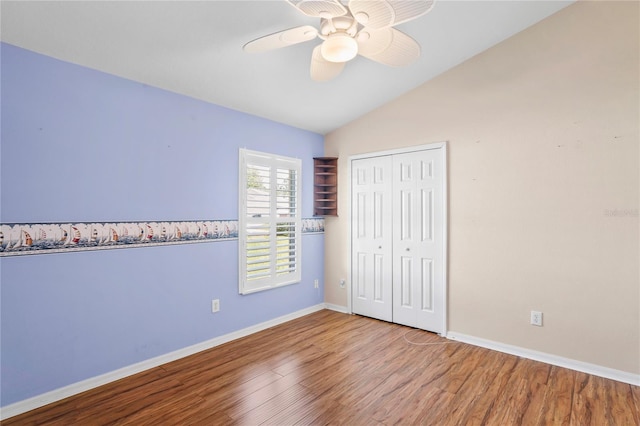 303 Rochester St, Spring Hill, FL 34609 - unfurnished bedroom featuring ceiling fan, baseboards, lofted ceiling, wood finished floors, and a closet