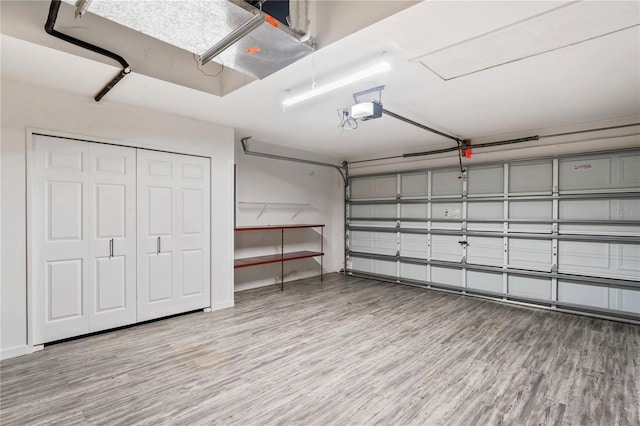303 Rochester St, Spring Hill, FL 34609 - garage featuring a garage door opener and baseboards