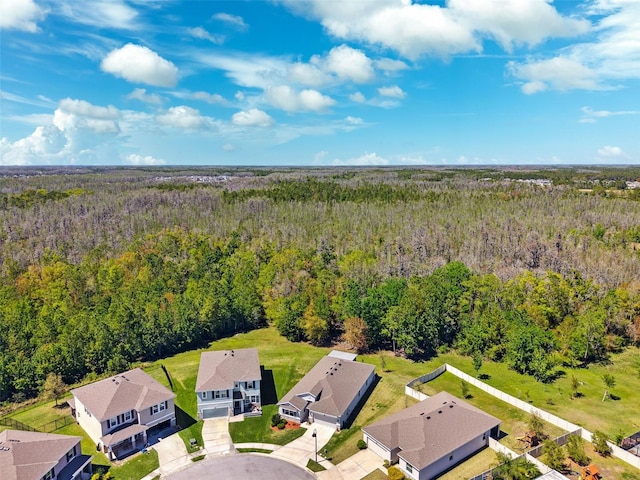 birds eye view of property featuring a forest view and a residential view