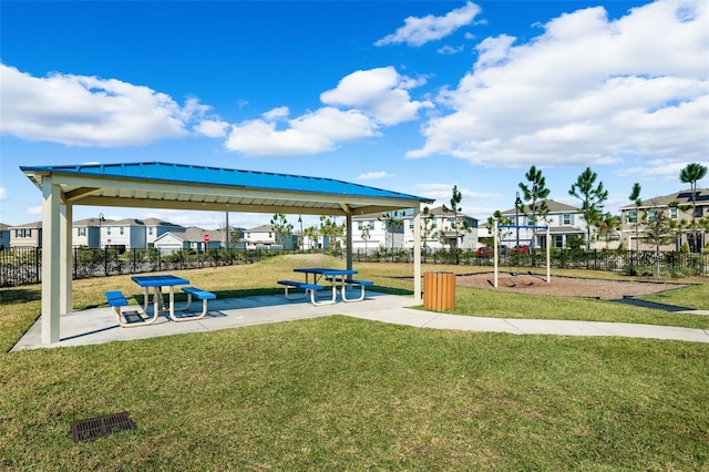 view of property's community featuring a residential view, a yard, and fence