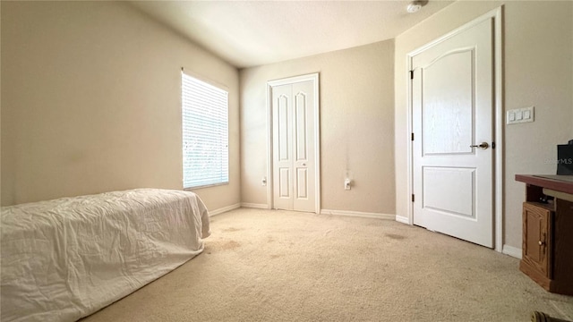 carpeted bedroom featuring baseboards