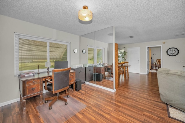 office featuring baseboards, a textured ceiling, and wood finished floors