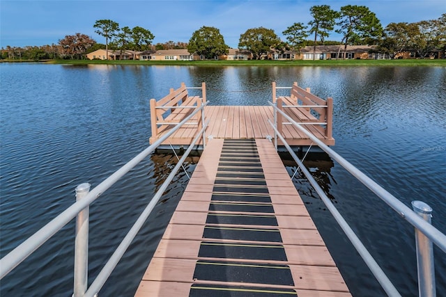 dock area featuring a water view and a residential view