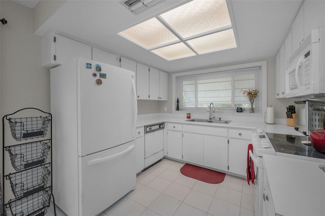 kitchen with visible vents, white appliances, light countertops, white cabinets, and a sink