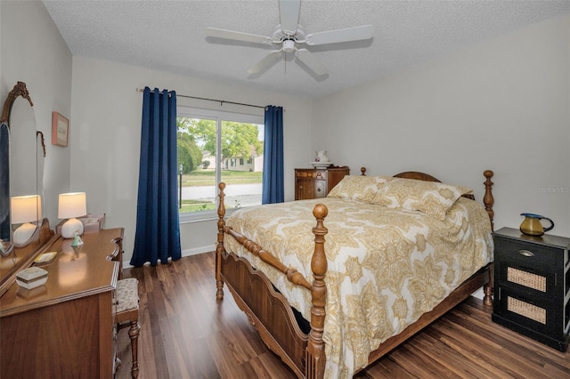 bedroom with baseboards, a textured ceiling, ceiling fan, and wood finished floors
