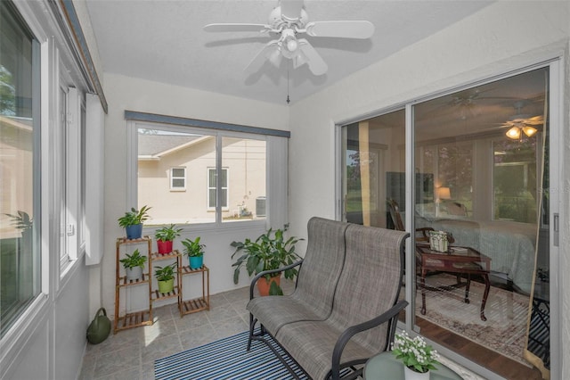 sunroom featuring a ceiling fan and a wealth of natural light