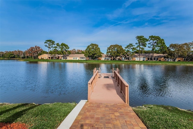 view of dock with a water view and a residential view