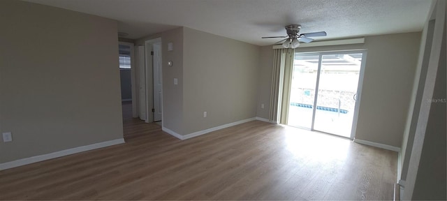 unfurnished room with ceiling fan, baseboards, and wood finished floors