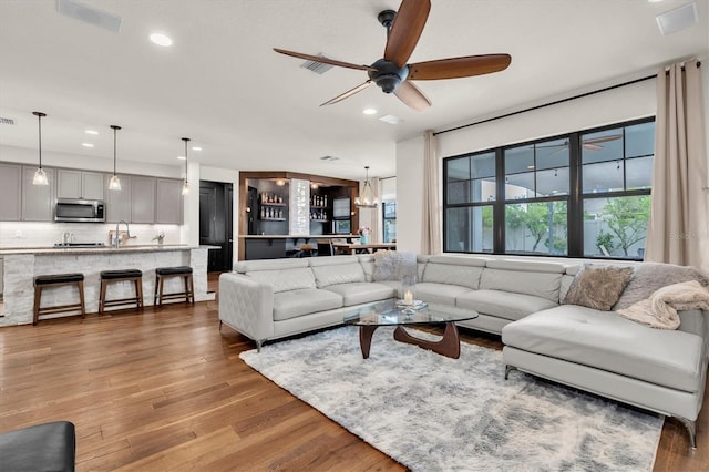 living room with wood finished floors, recessed lighting, visible vents, and ceiling fan