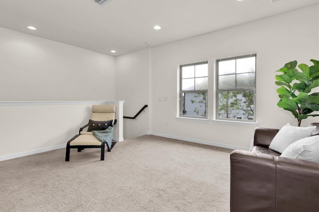 sitting room with carpet floors, an upstairs landing, baseboards, and recessed lighting