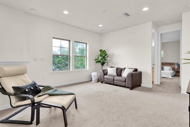 carpeted living room with baseboards, visible vents, and recessed lighting