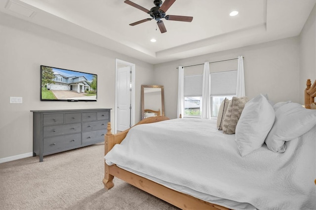 bedroom with carpet floors, recessed lighting, and a raised ceiling